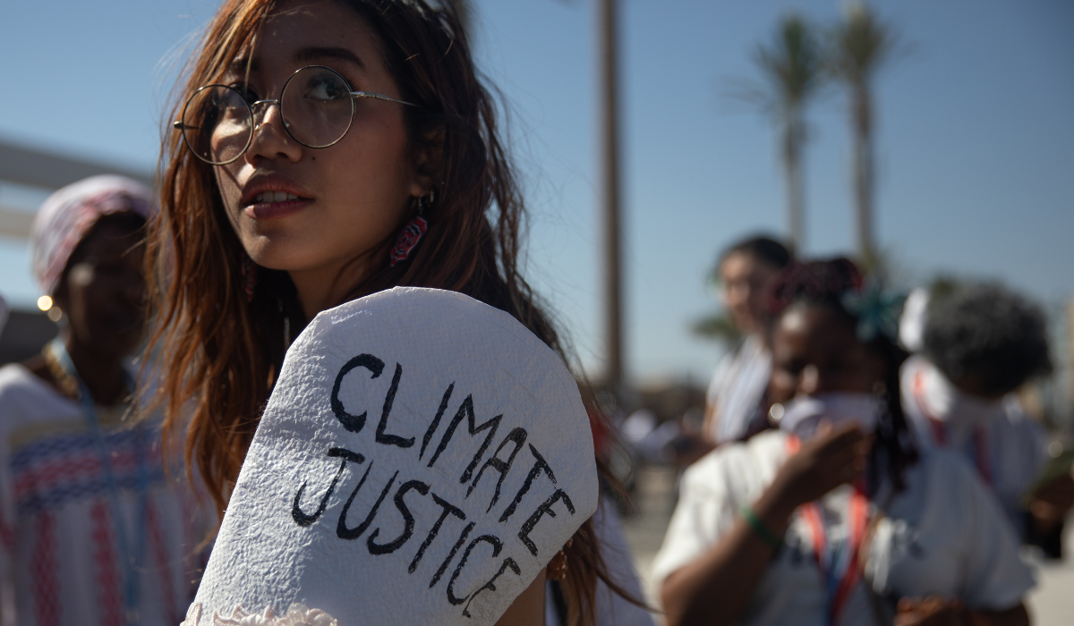 person holding climate justice sign