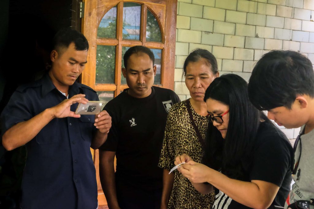 Community members from Nan learn about techniques for testing the quality of their local water sources.