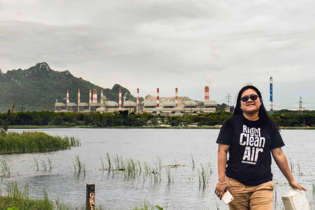 EarthRights International Mekong Legal Bertha Fellow Chompoo in front of the Mae Moh coal-fired power plant.