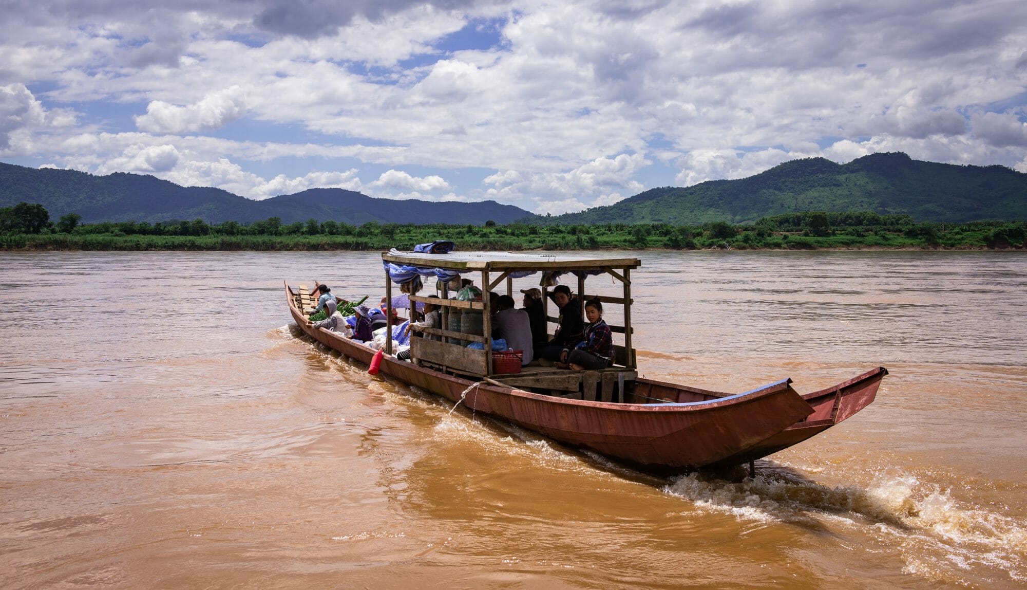 A boat crosses the Mekong River in northern Thailand near Chiang Khong.
